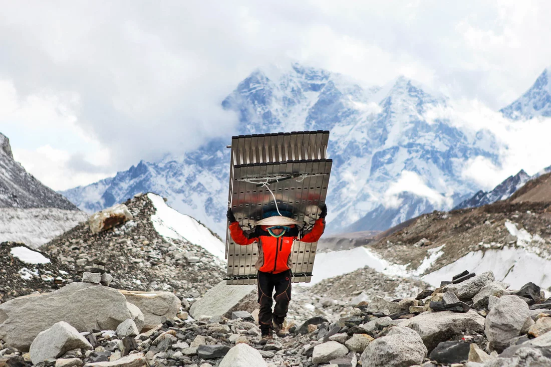 A Sherpa fetches ladders for climbers attempting to summit Mount Everest.